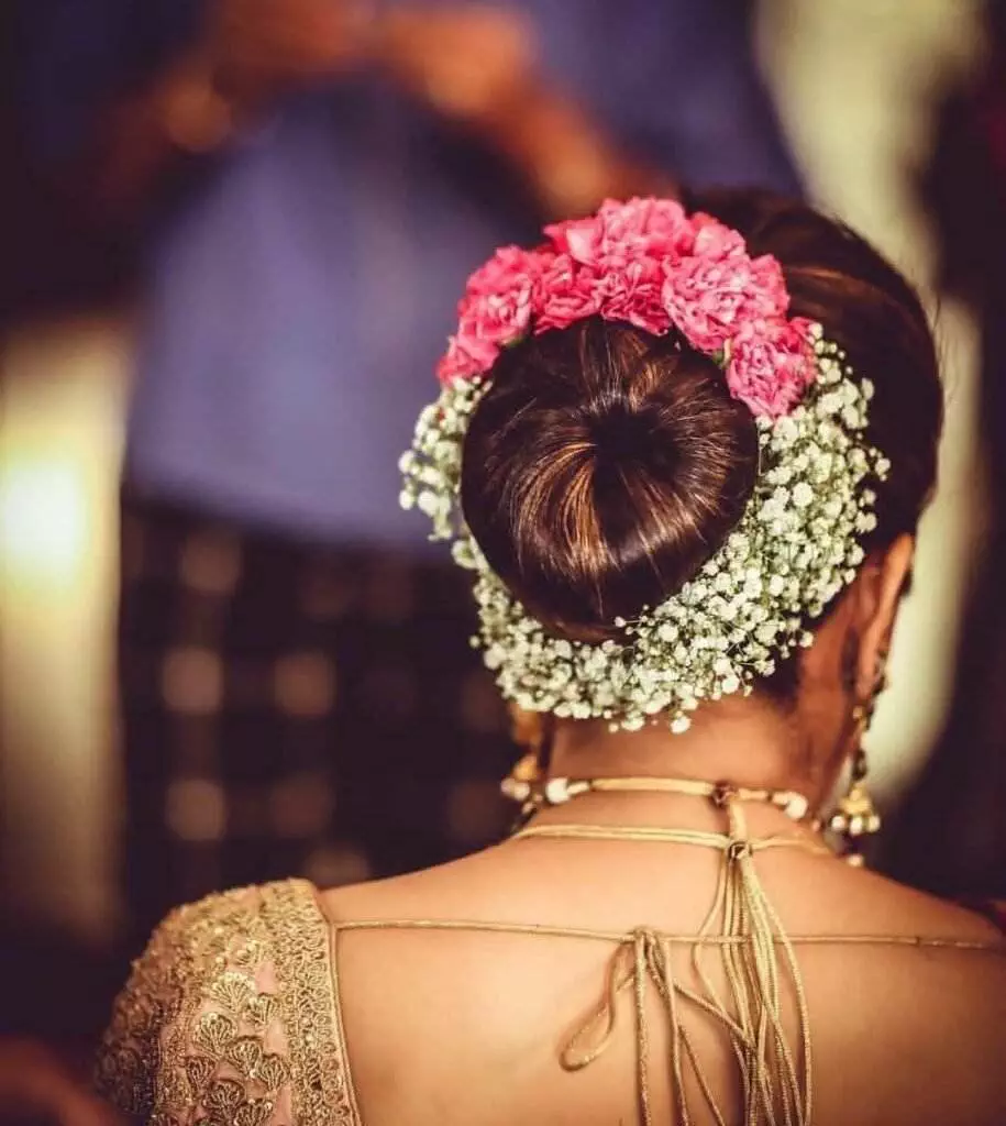 curl bun updo with silver flower pins for the Indian Bride | Photo Source -  Kim Jones Photography | Curated by Witty Vows - Witty Vows